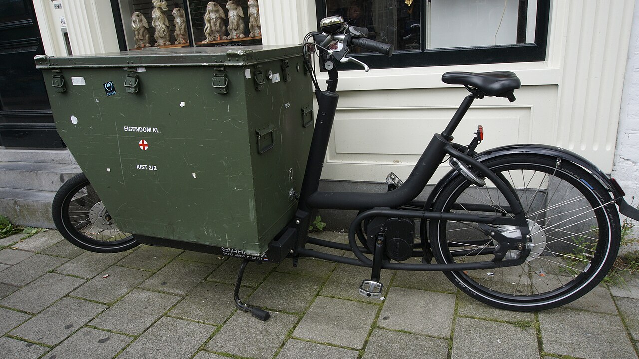 Mécanicien réparant un vélo cargo dans un atelier parisien